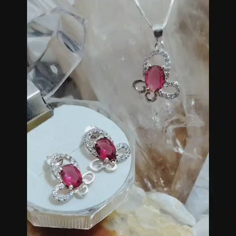 Conjunto mariposa con circón magenta e incrustaciones